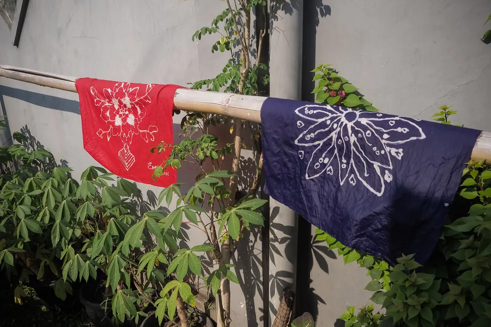 Finished batik cloths with hand-drawn motifs drying on a line