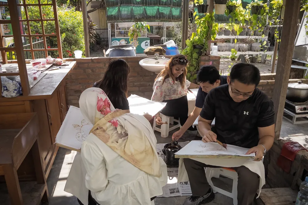 Guests at work on their stretched cloth under the studio pavilion